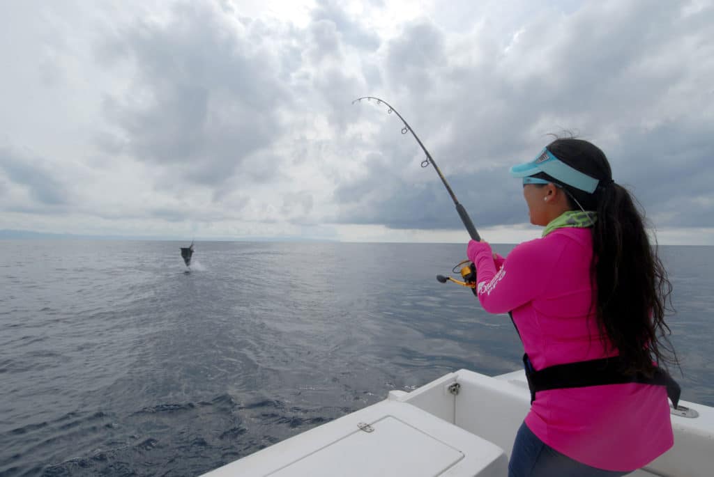 Angler catching fish using spinning tackle