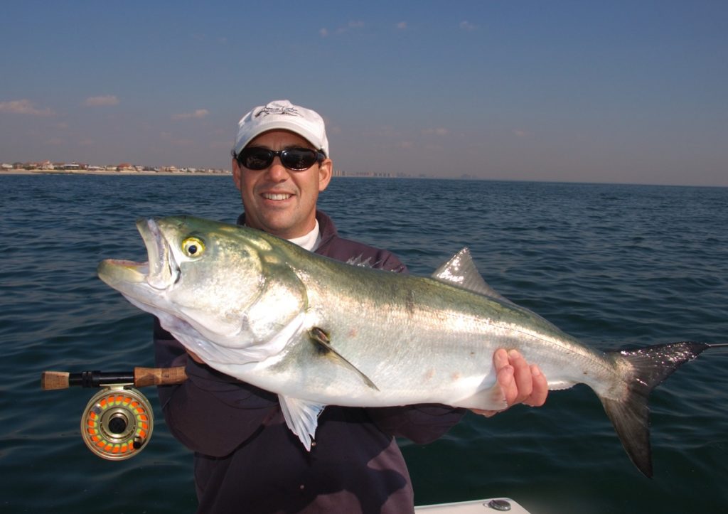 Flyfisherman holding a fish in Montauk, New York