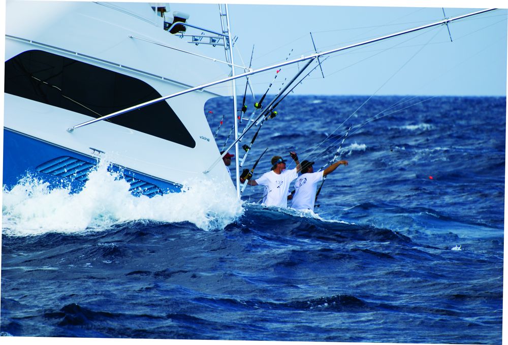 Crew adjust trolling lines in a big sea