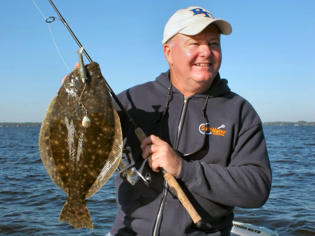 Angler holding a flounder