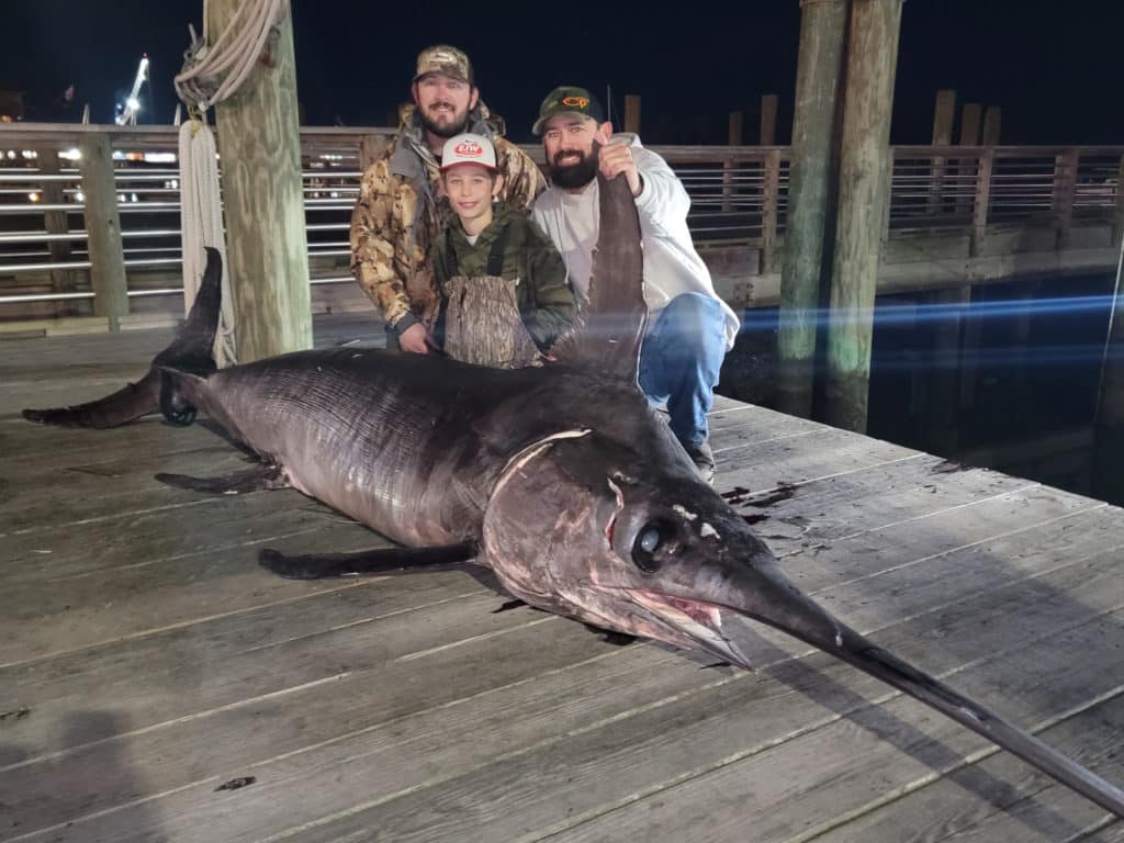 Family with massive swordfish